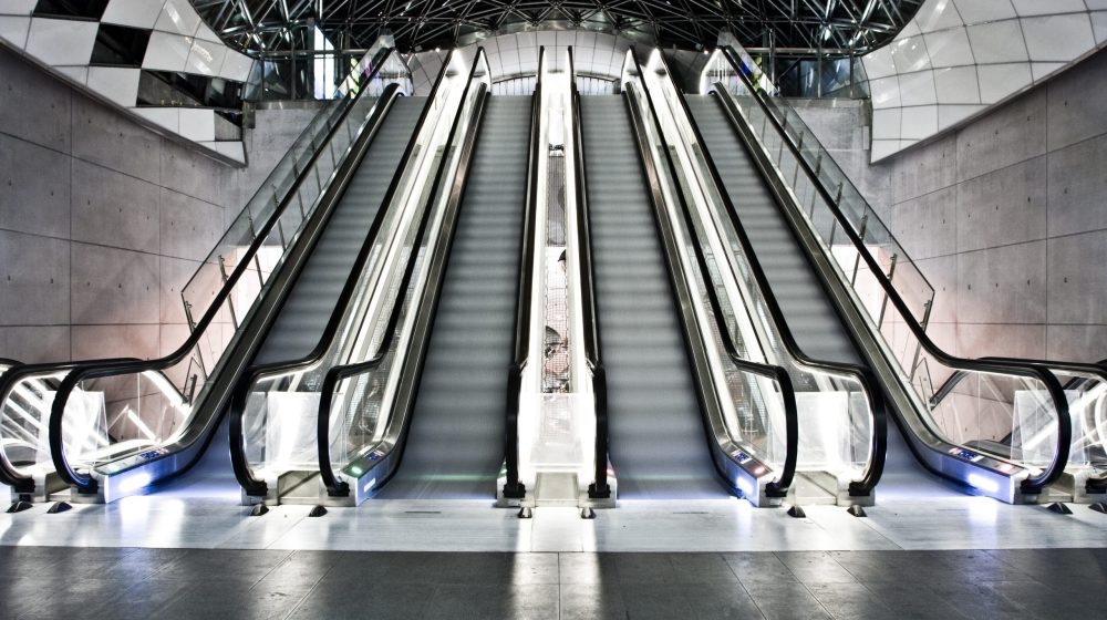 An interior shot of a building with escalators